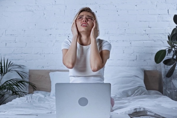 woman covering ears while hearing unusual air conditioner sounds