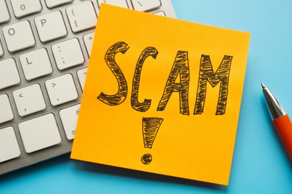 SCAM word written on a sticky note depicting air conditioner