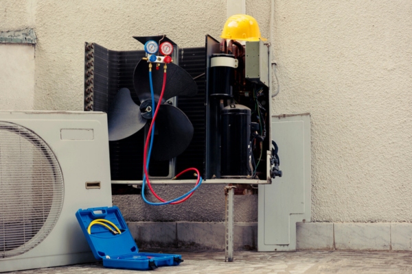external air conditioner unit exposed during part replacement
