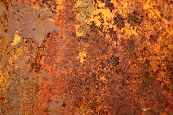 rusty metal surface depicting Effects of Summer Heat and Moisture on Heating Oil Tanks