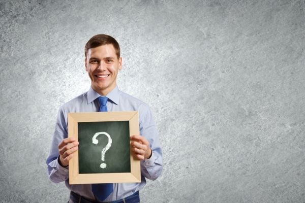 man holding a mini board with question mark depicting Furnace Preparation Tips FAQs